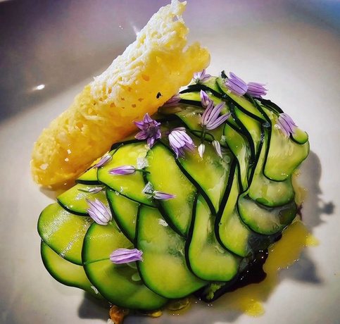 Shaved zucchini with a parmesan crisp and chive blossoms